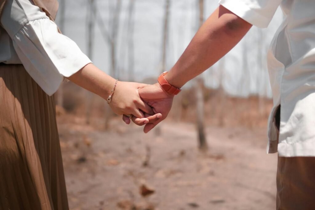 Two people holding hands