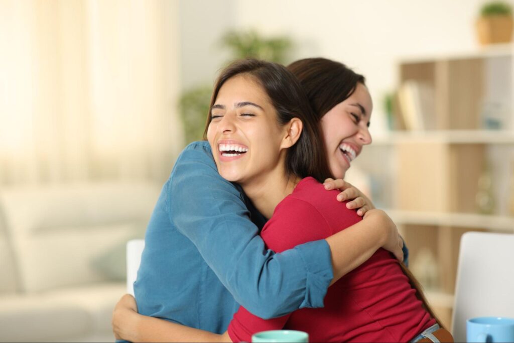 two women hugging each other