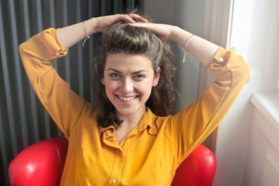 A happy woman in a yellow shirt