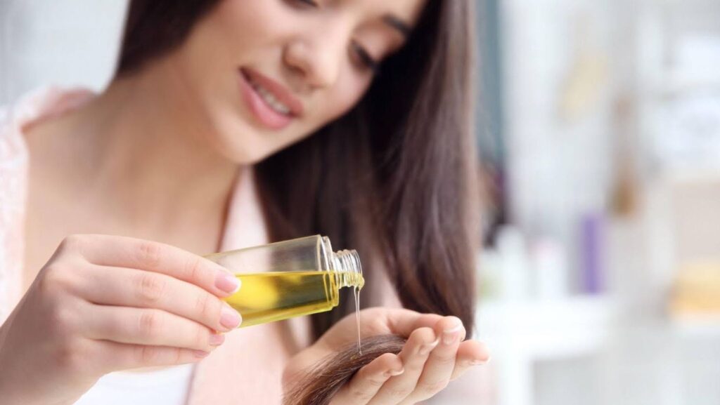 A young woman applying abyssinian seed oil at home.