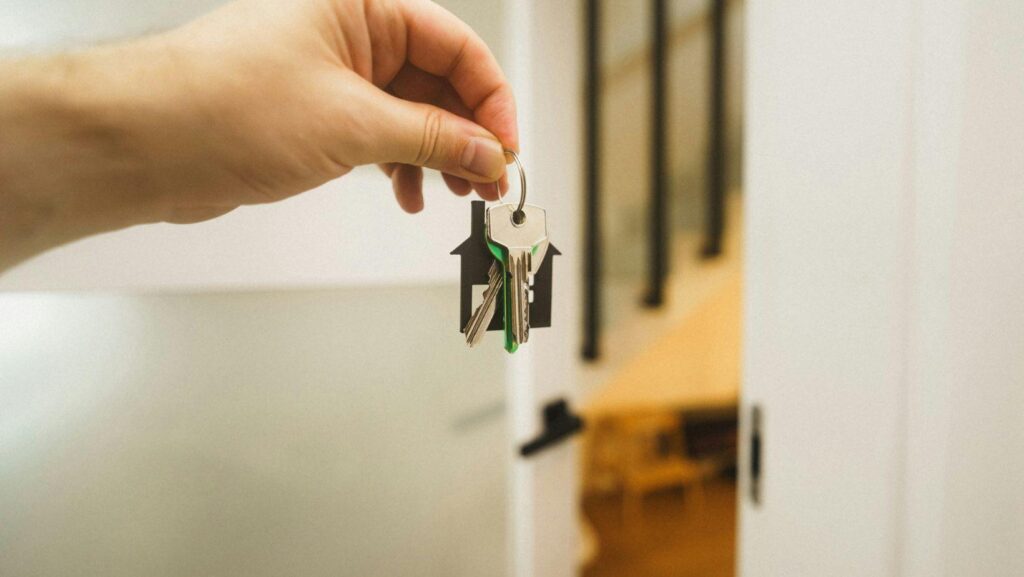 A letting agent handing over house keys to a new tenant